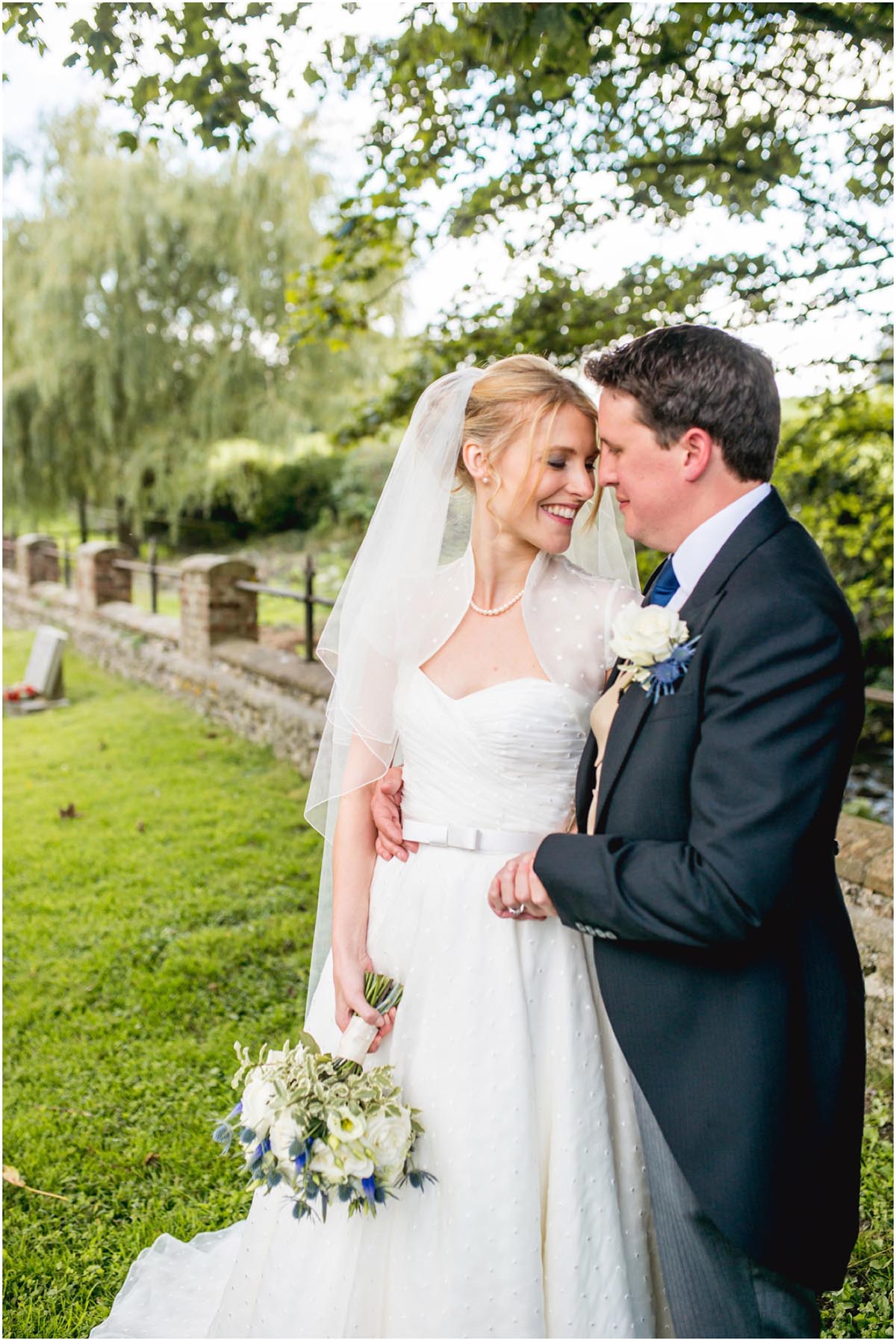 Bride and groom look at each other lovingly after a Dorset Wedding in Cerne Abbas.