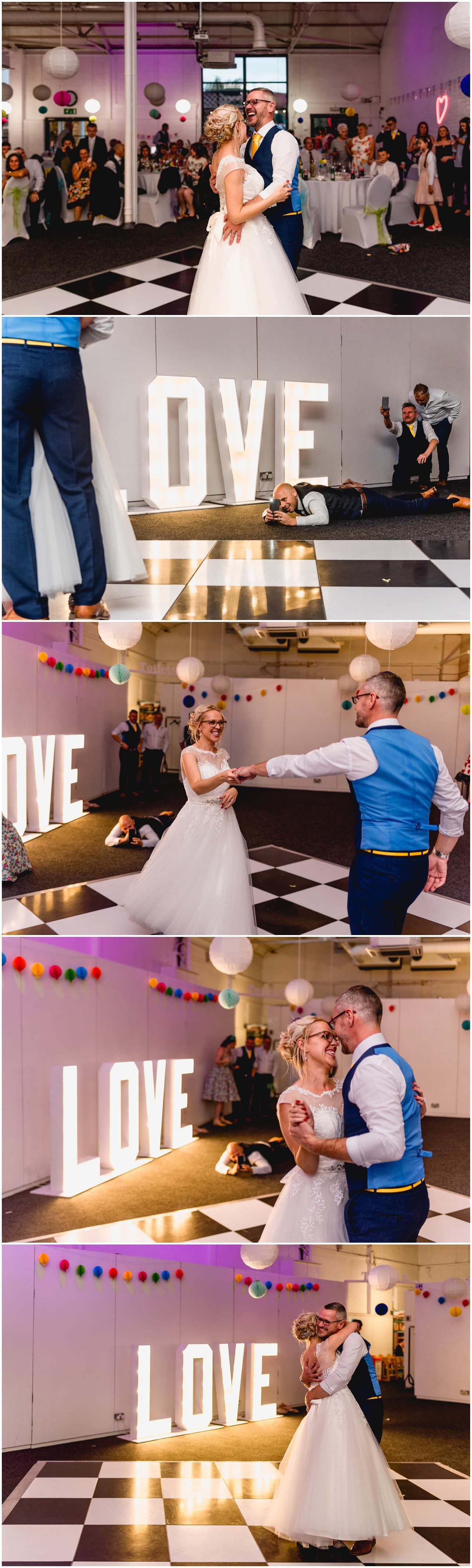 First dance against giant illuminated LOVE letters on the dance floor at The Bond Company.