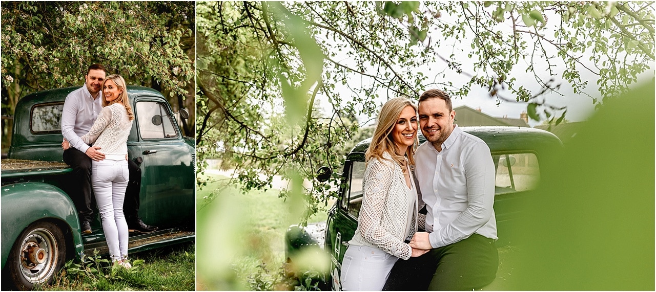 Bride and groom on engagement shoot leaning against old Chevrolet truck