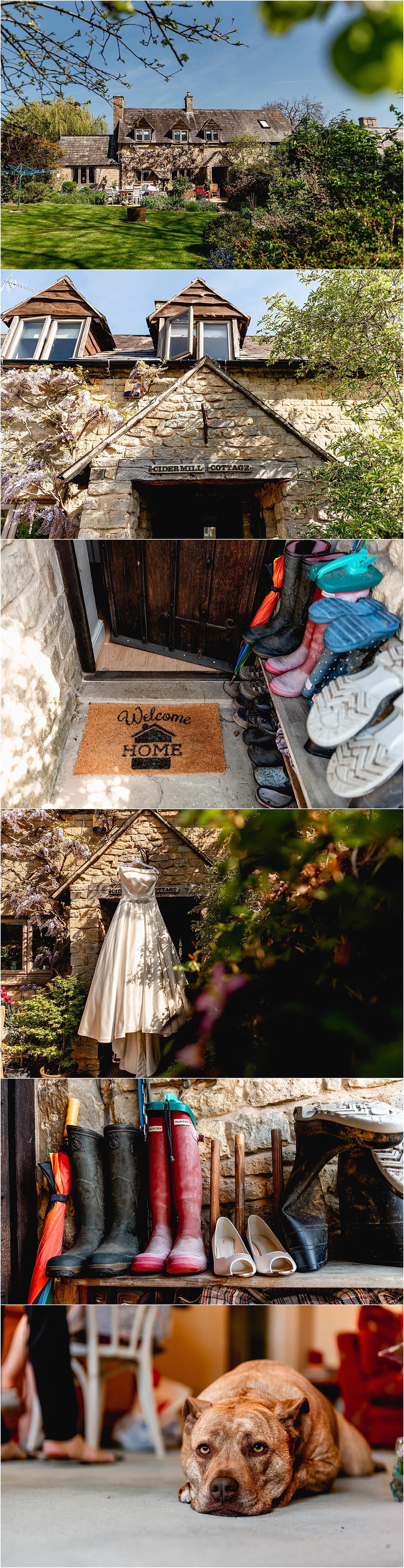 Wedding dress hanging in doorway of beautiful cottage on the morning of a wedding in Chipping Camden