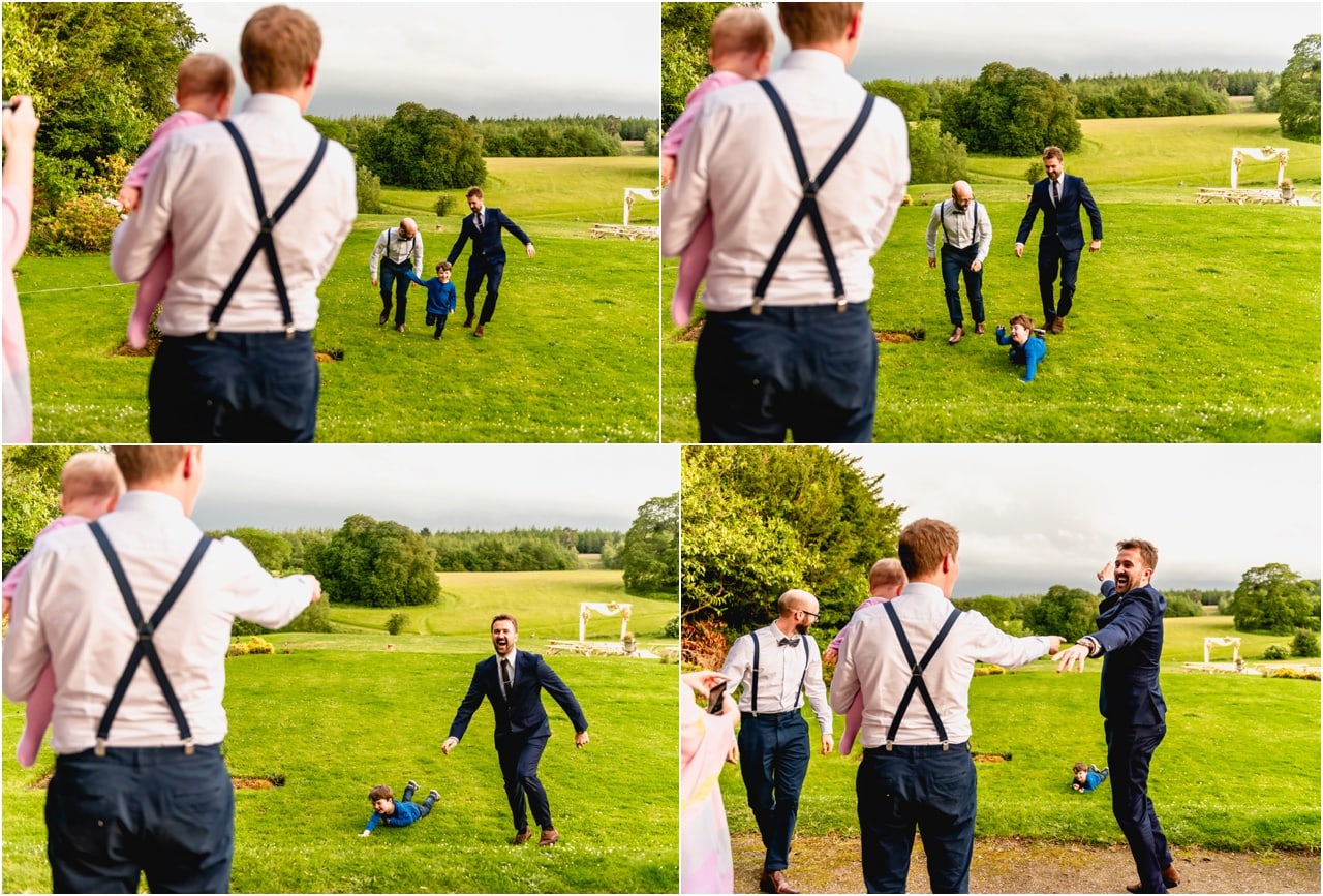 Wedding guests have races with children at Buckland House. Child falls over, wedding guests laugh.