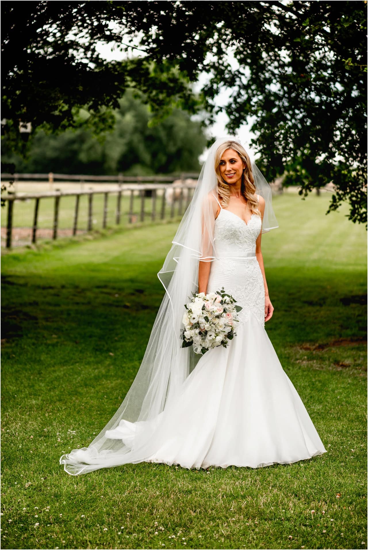 Bride's portrait, bride in long white fishtail dress and veil at wedding at home in Sutton Coldfield.