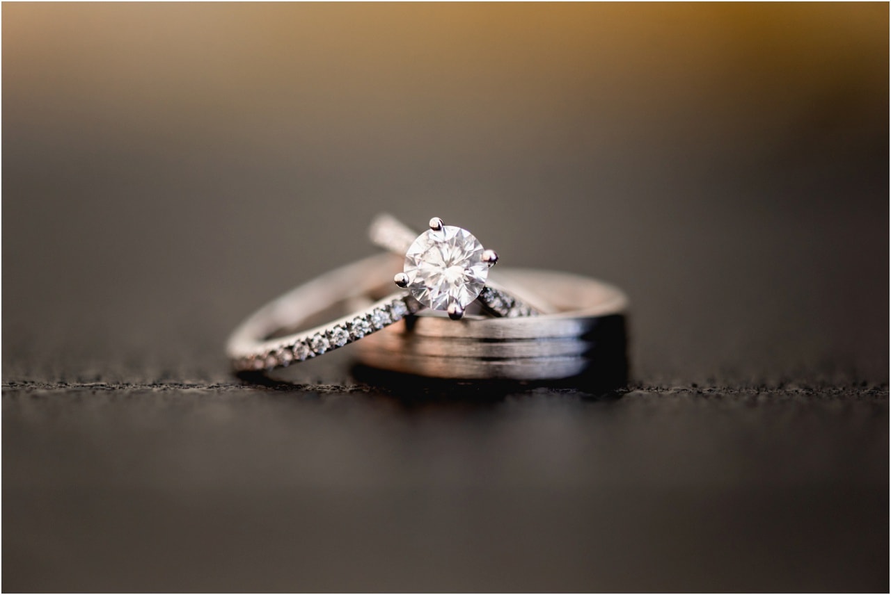 Wedding and engagement rings against black backdrop