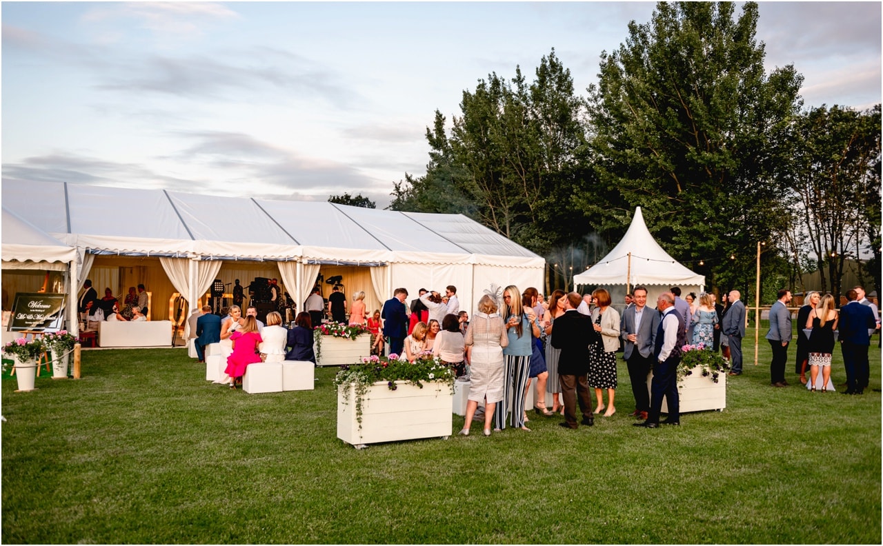 Guests enjoy themselves at a wedding in Sutton Coldfield outside the marquee