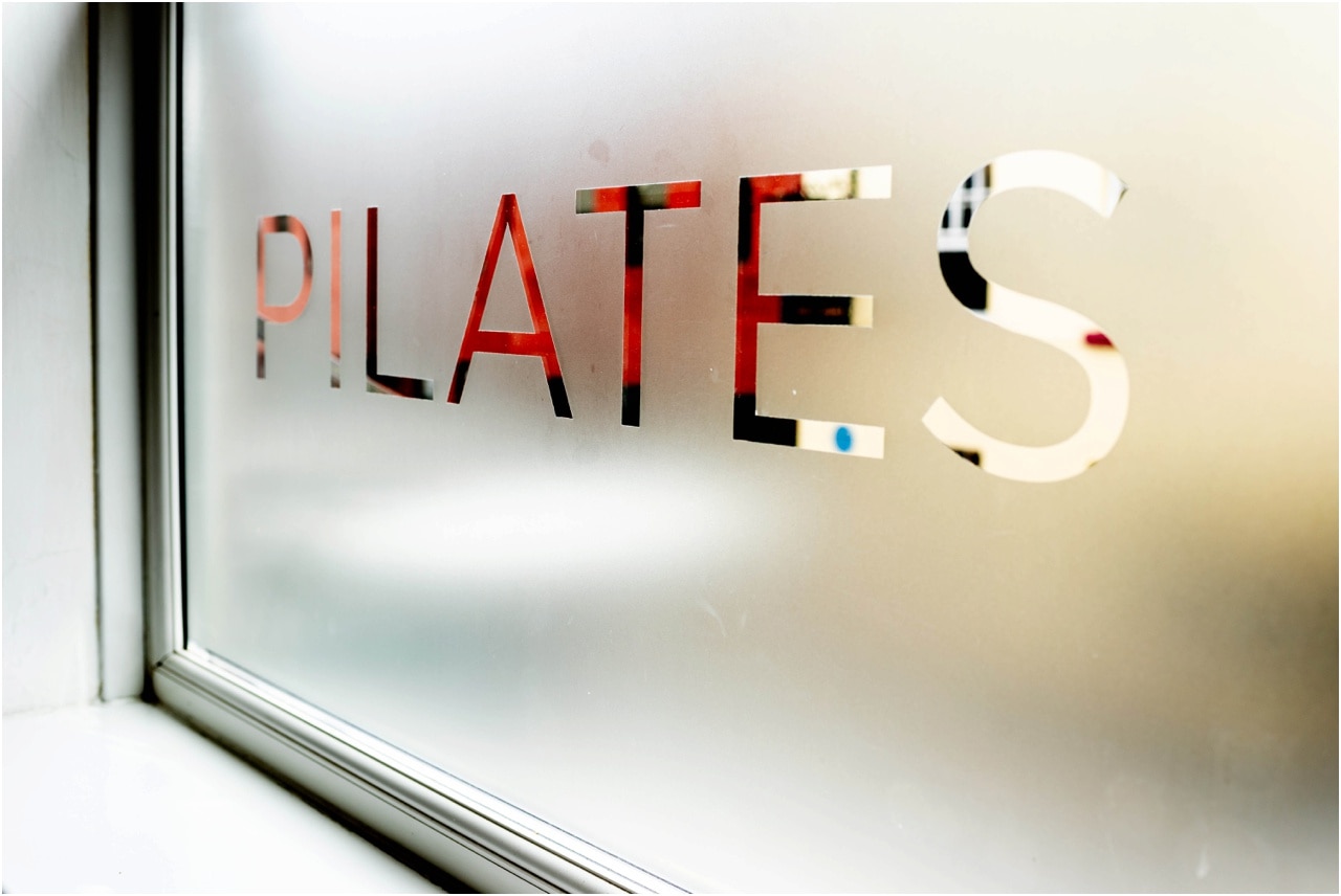 Frosted window with Pilates text etched into the glass at Pilates Lounge in Birmingham. Small Business photography.