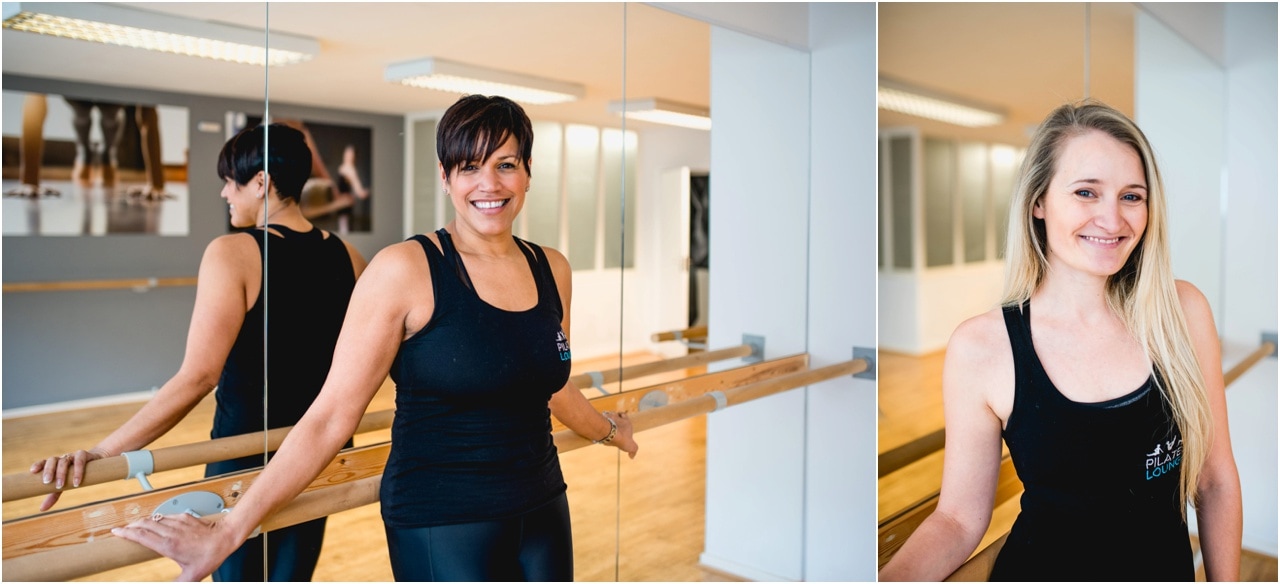 Small business photography of Pilates Lounge instructor Katie leans against the bar in a mirrored studio for her portrait photo in a personal business branding session.