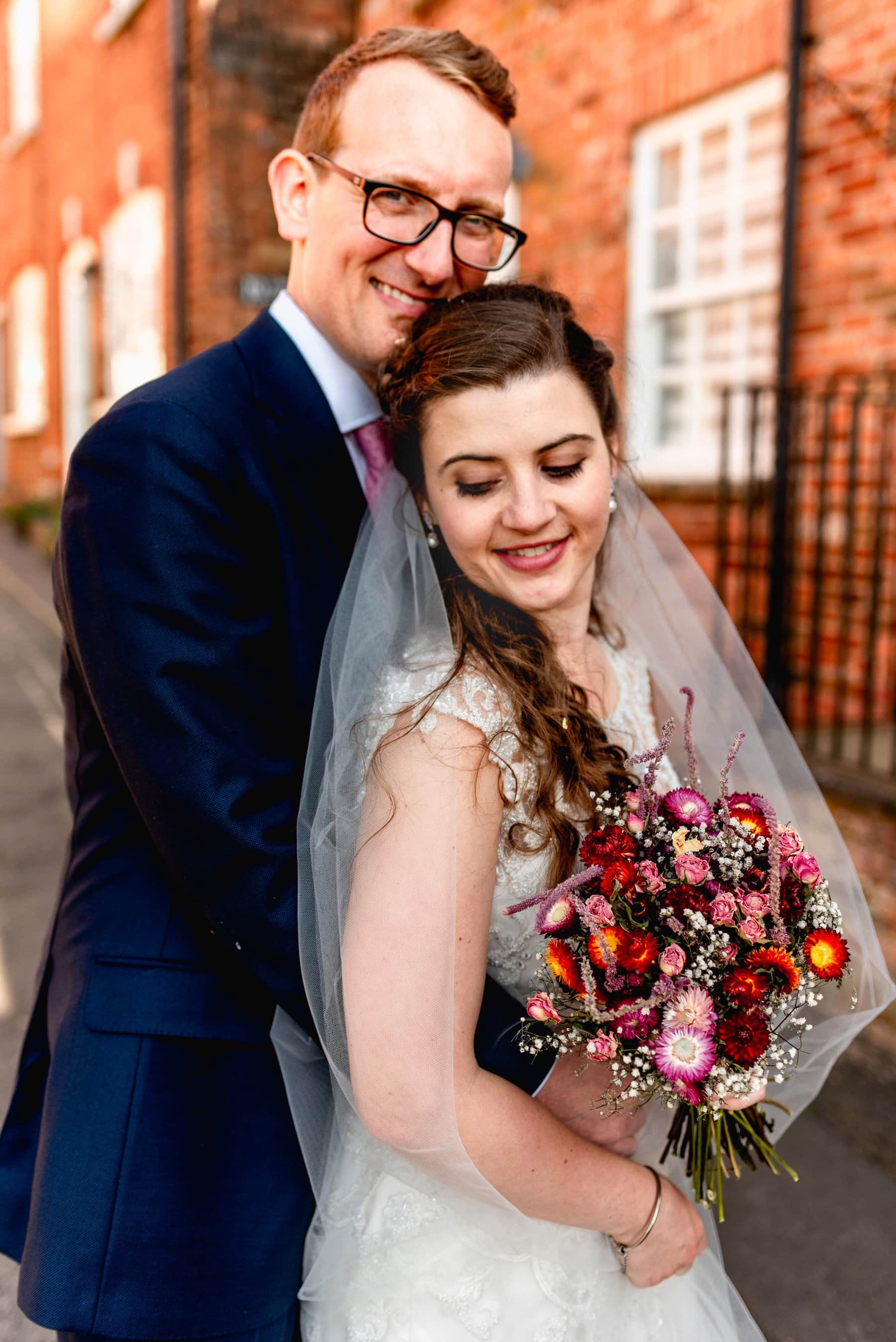 Couple portrait against the backdrop of a market town streets.