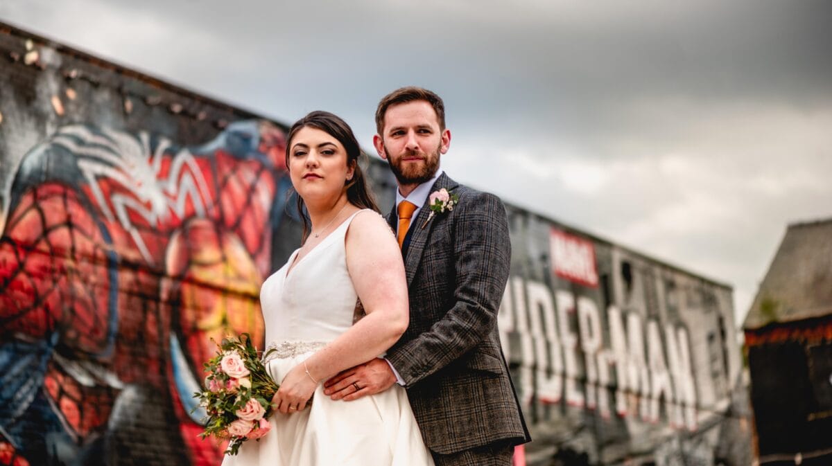 Urban wedding portrait against backdrop of Spiderman graffiti in Birmingham