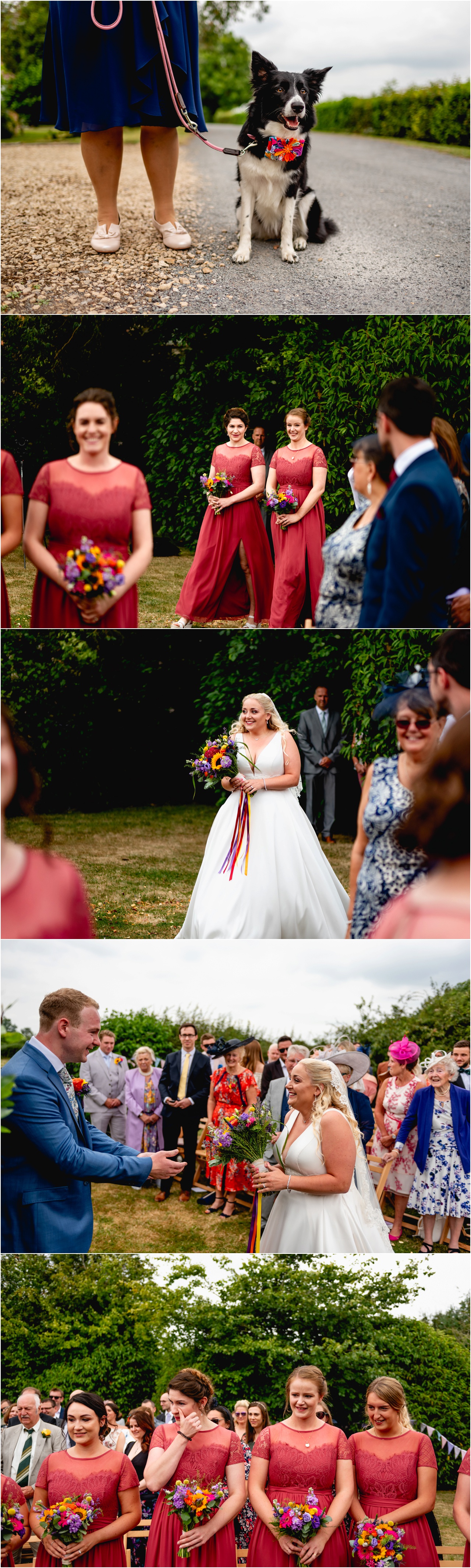 Bride arrives at her outdoor ceremony during her wedding at Pennard Hill Farm in Glastonbury wearing a white full length dress, bridesmaids wear red dresses and groom wears a blue suit