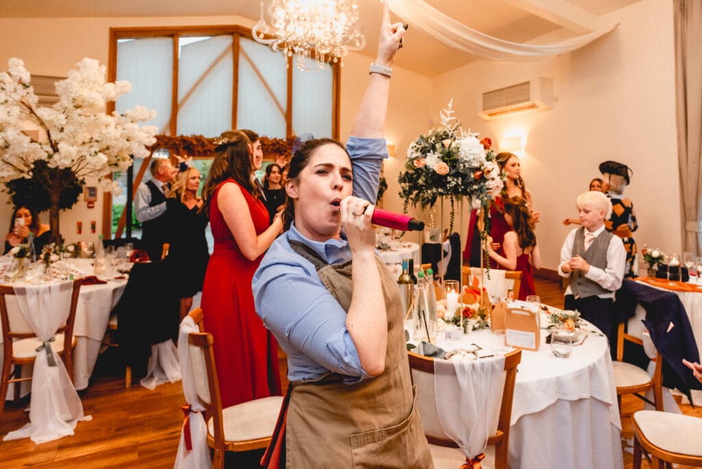 singing waiters get the crowd dancing at Mythe Barn wedding venue
