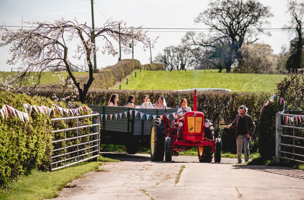 Bridesmaid drives bride to wedding in a tractor