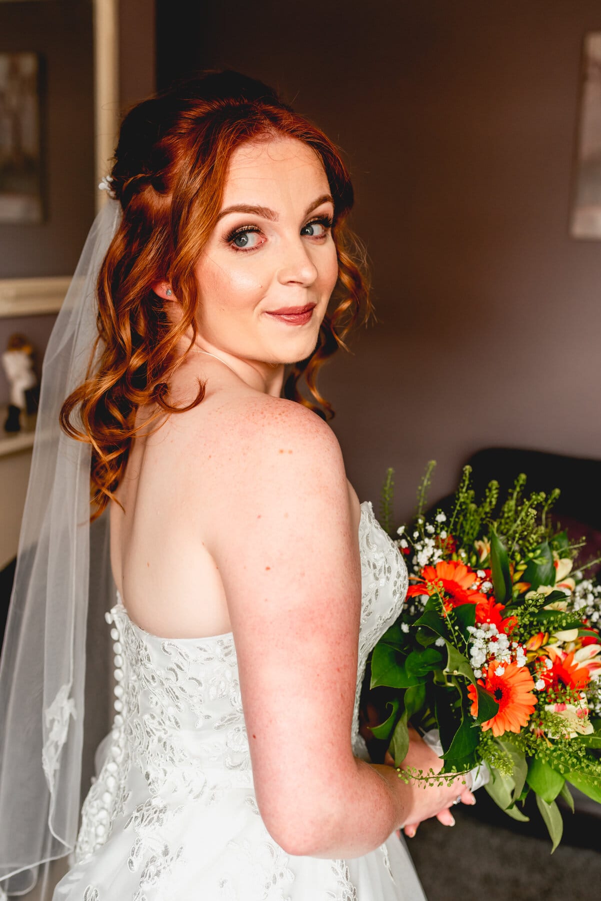 Bridal portrait with orange flower bouquet