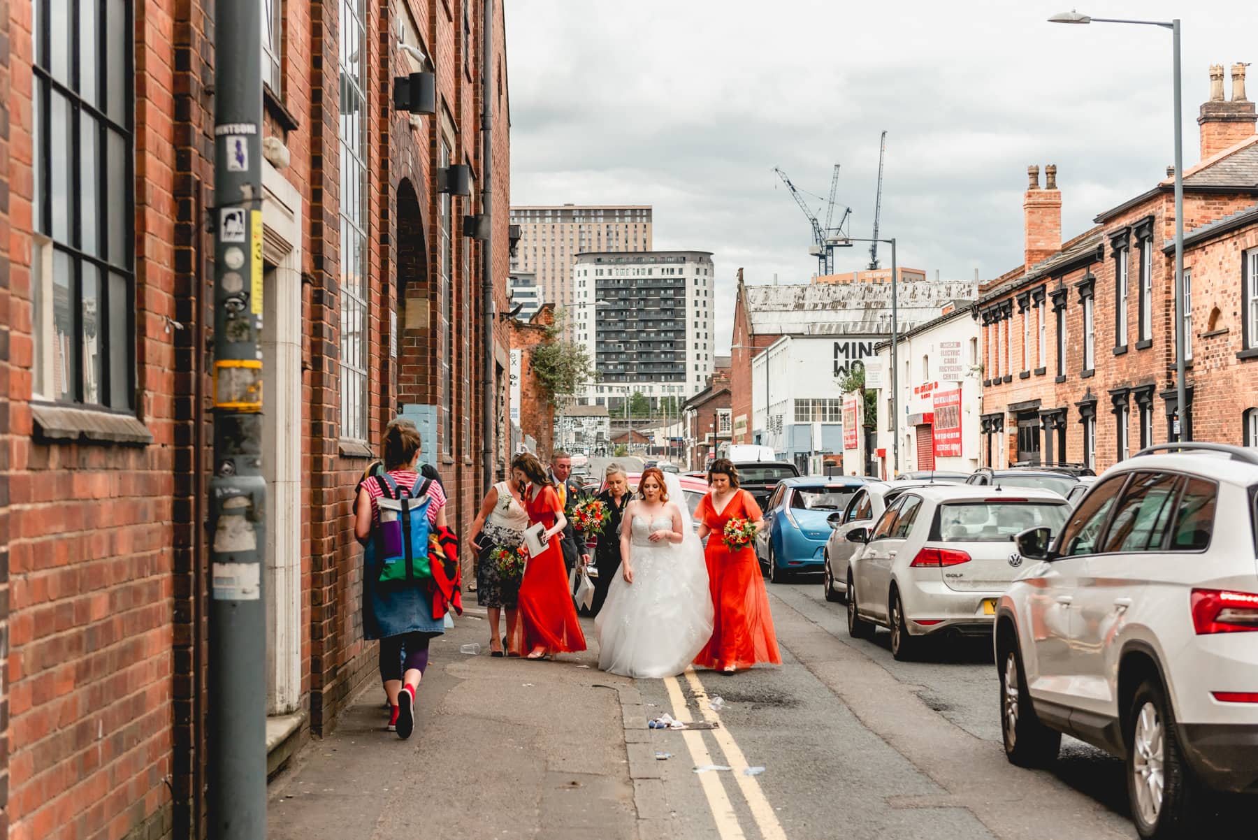 Bride and her family walk down the streets of Digbeth on their way to a wedding at Fazeley Studios in Digbeth