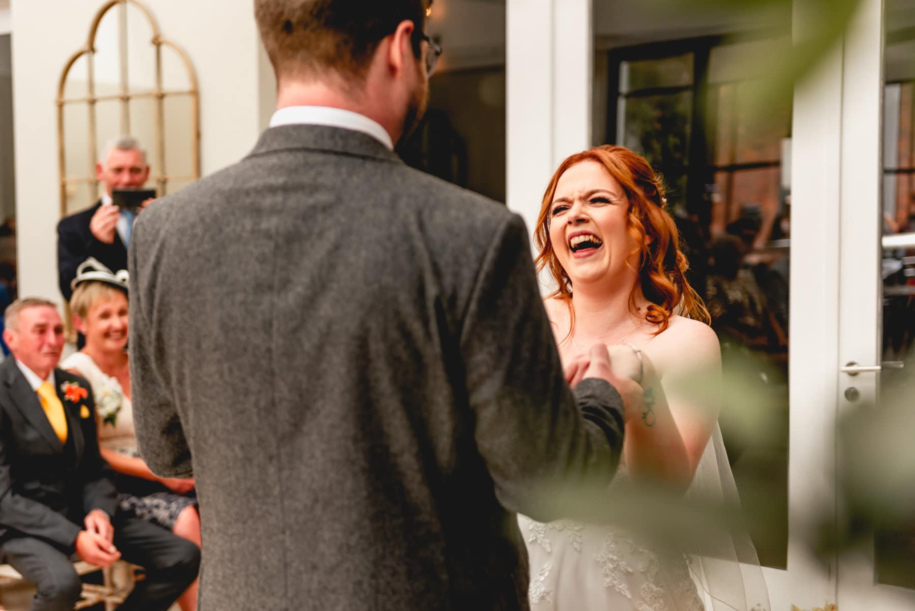 Wedding ceremony, couple laugh with each other