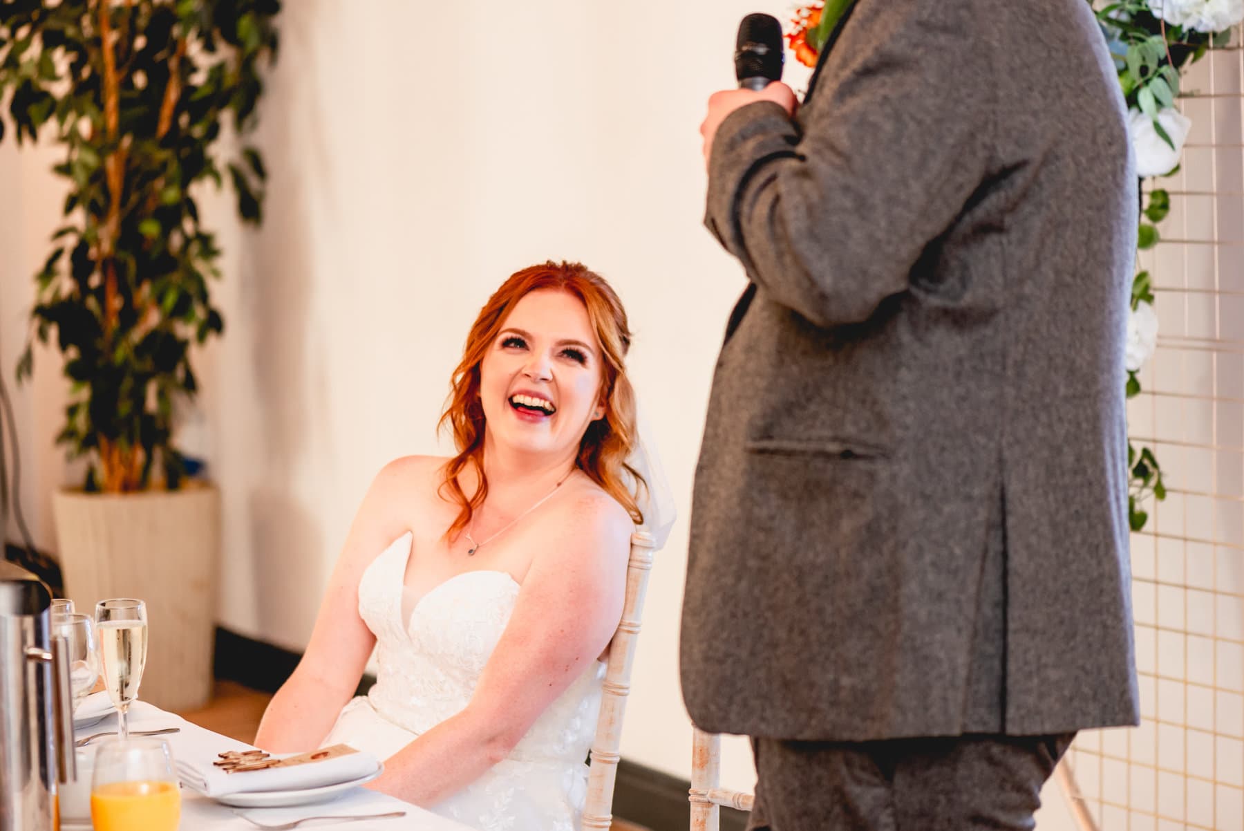 Bride laughs at grooms speech