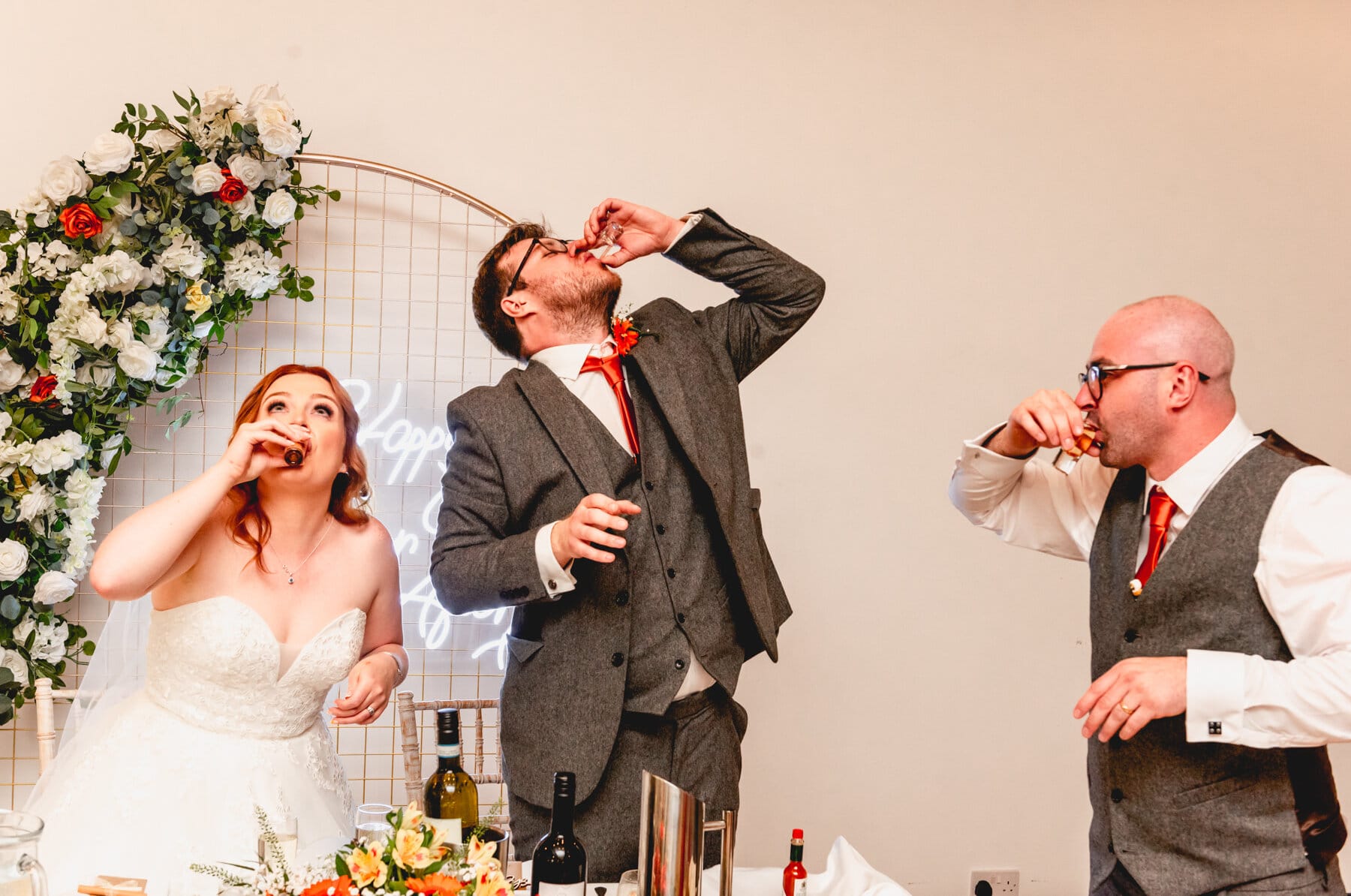 Couple drink tequila shots with best man