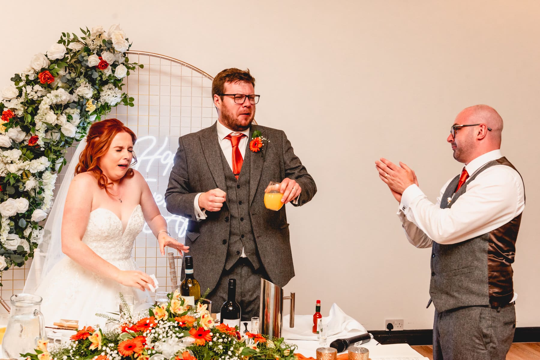 Aftermath of tequila shots at a wedding during speeches, bride and groom pull disgusted faces
