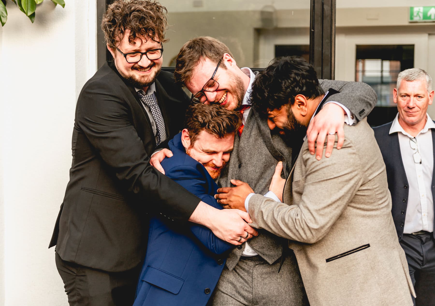 Groom hugs his friends