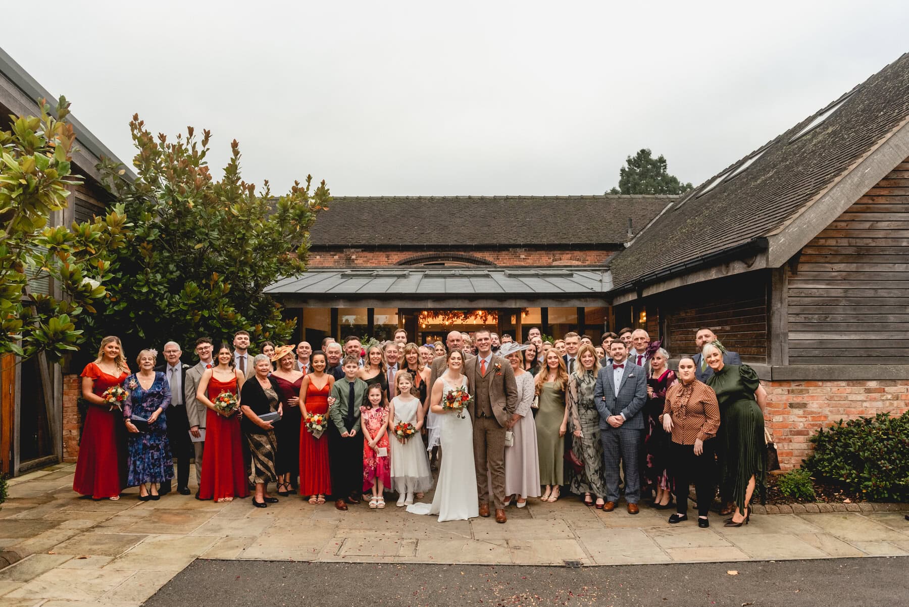 group photo of wedding guests after wedding ceremony at Mythe Barn