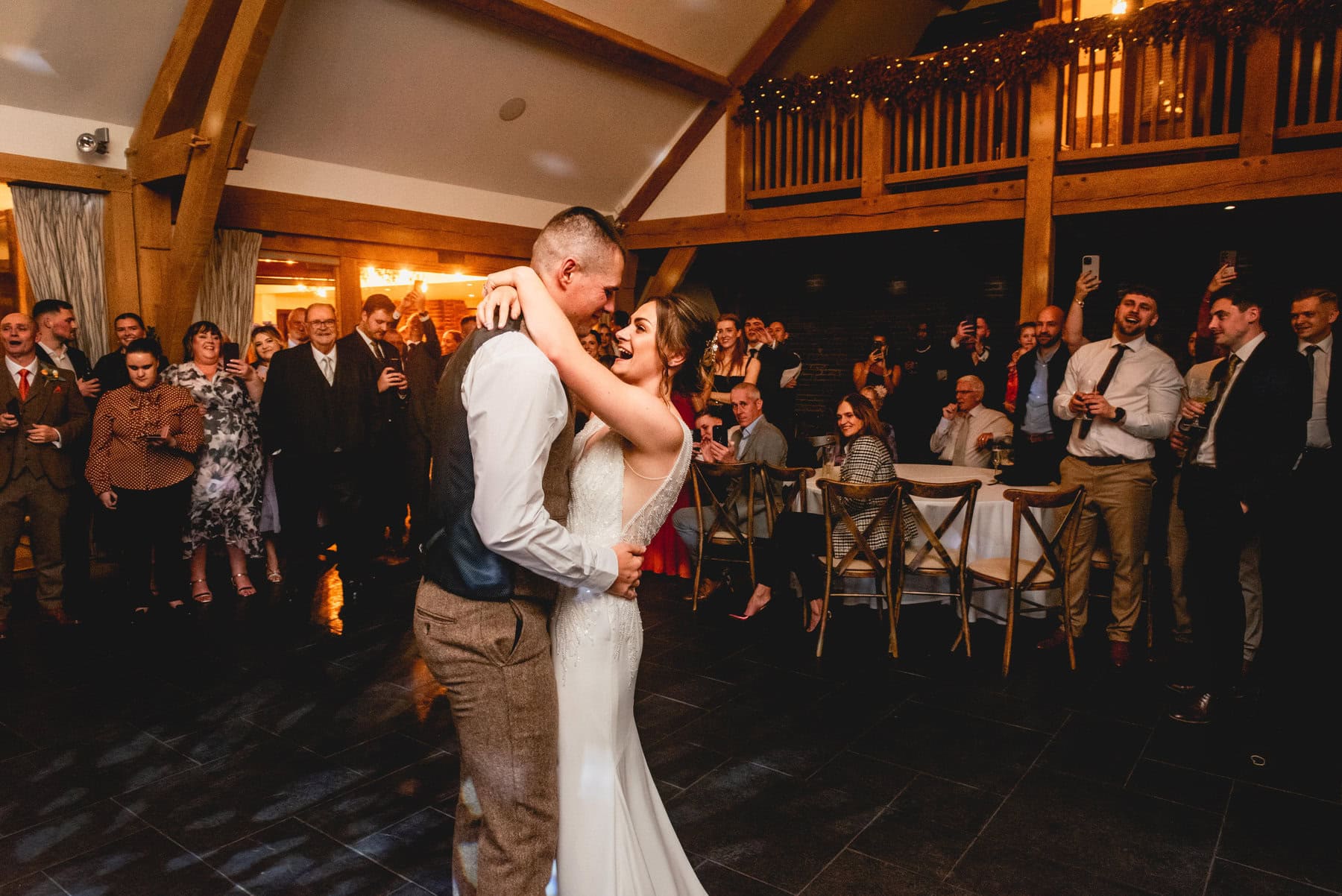 bride and groom have first dance in barn venue