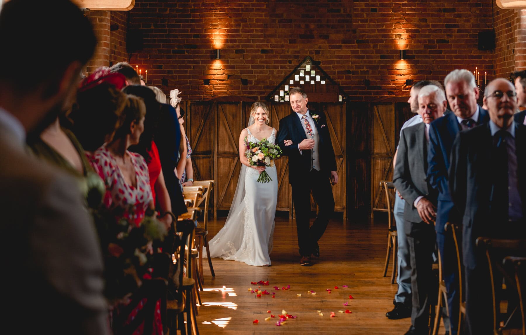 Bride and father walk down the aisle to her wedding