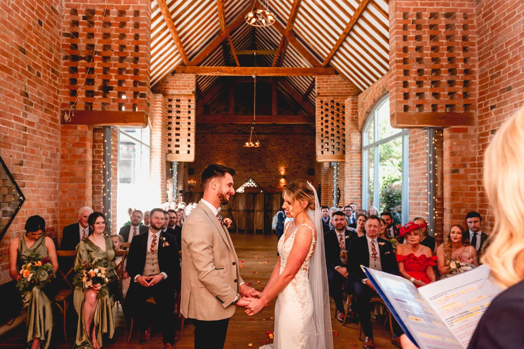 Bride and groom during wedding ceremony. Swallows Nest Barn