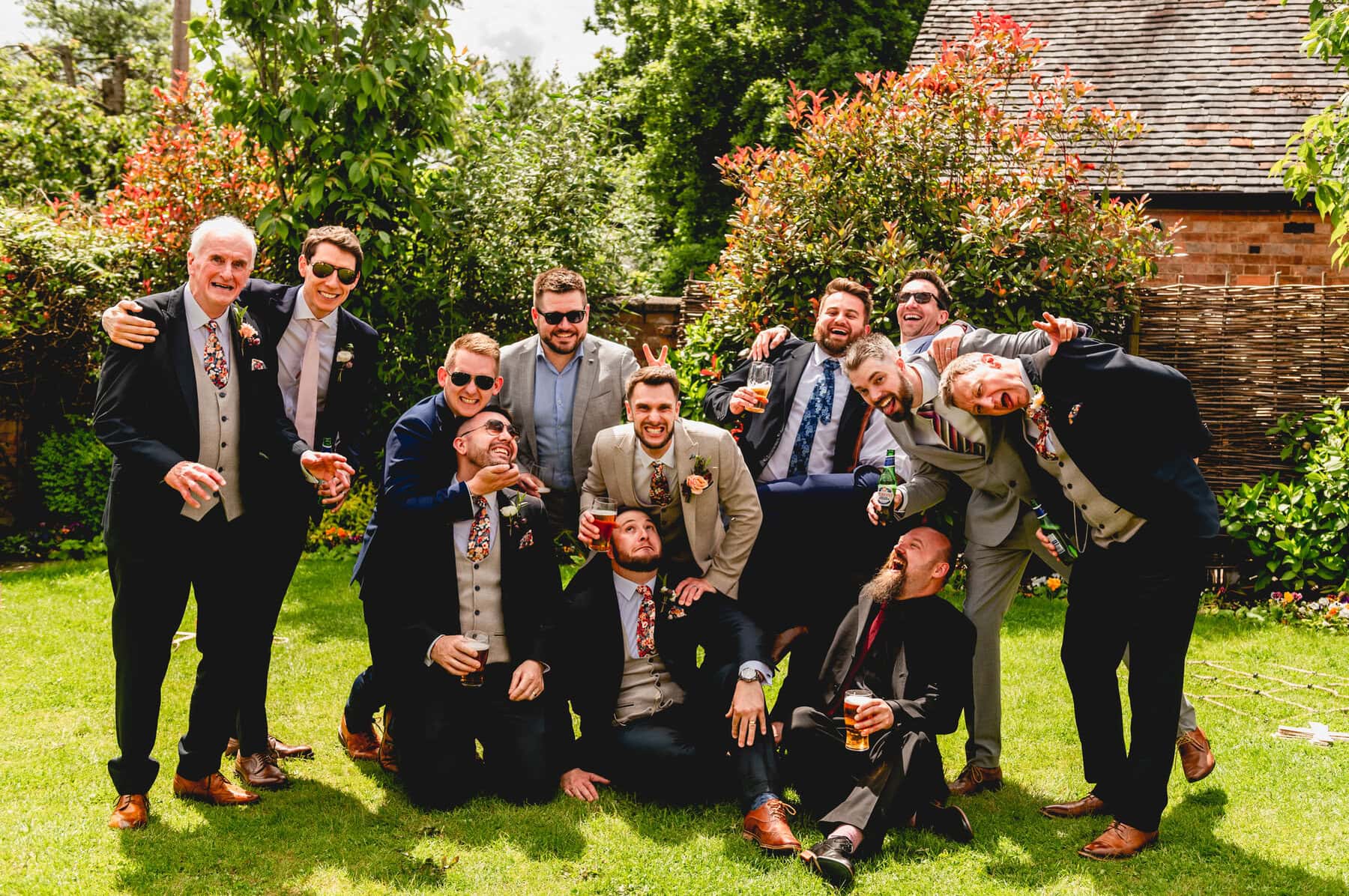 Group photo of men at a wedding cheering