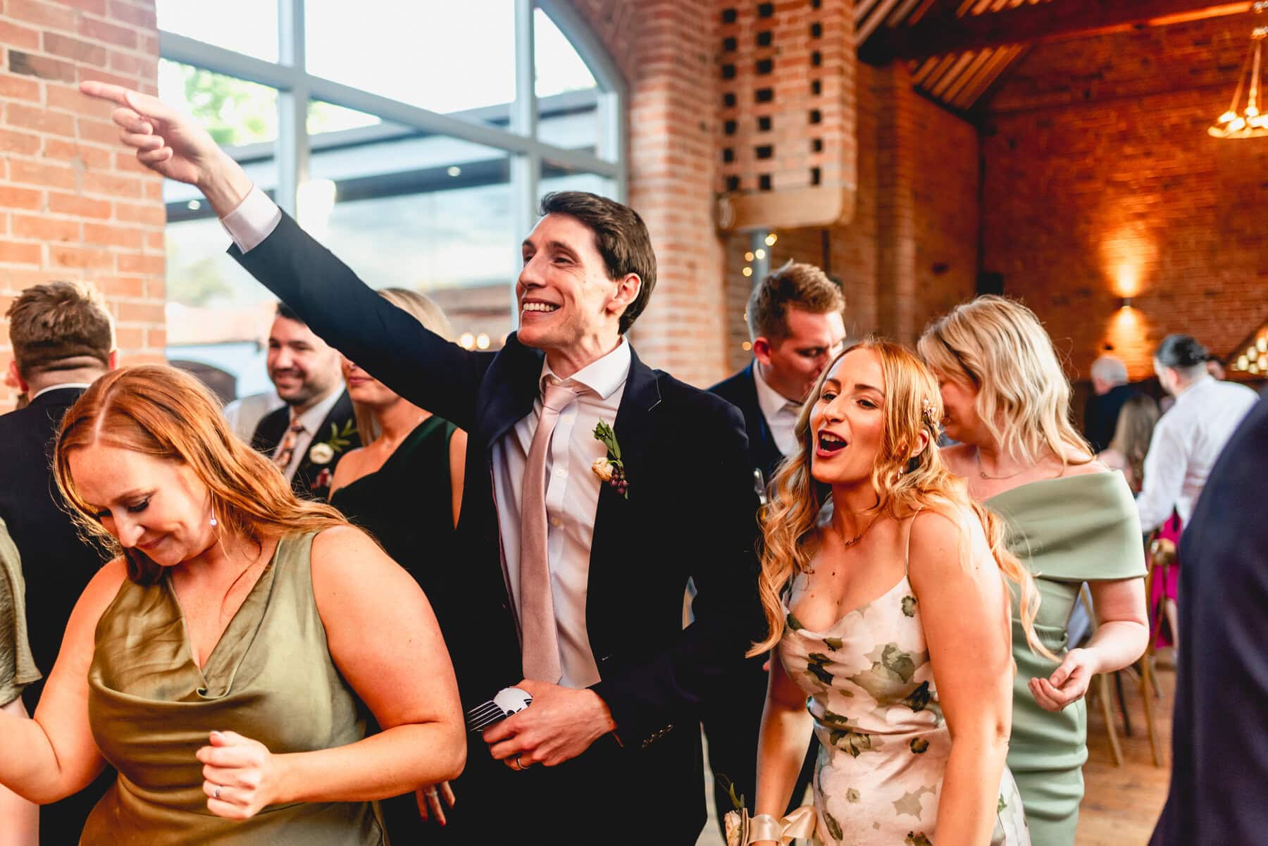 Guests cheer during the wedding party on the dancefloor