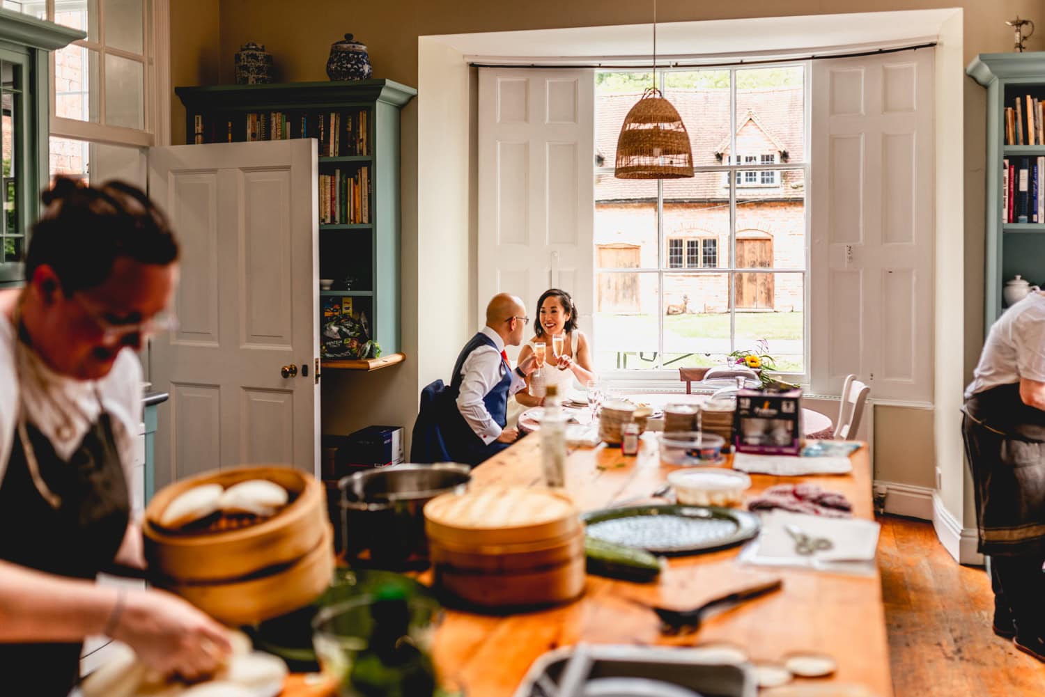 Couple eat in the kitchen during a quiet moment at their wedding