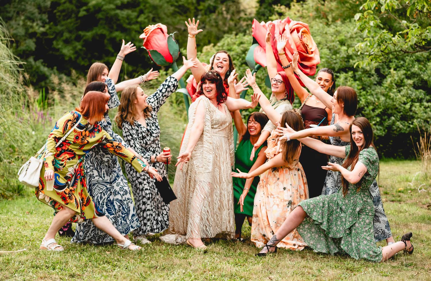 Bride surrounded by her girlsfriends and huge roses to celebrate her wedding at Blyth Hall